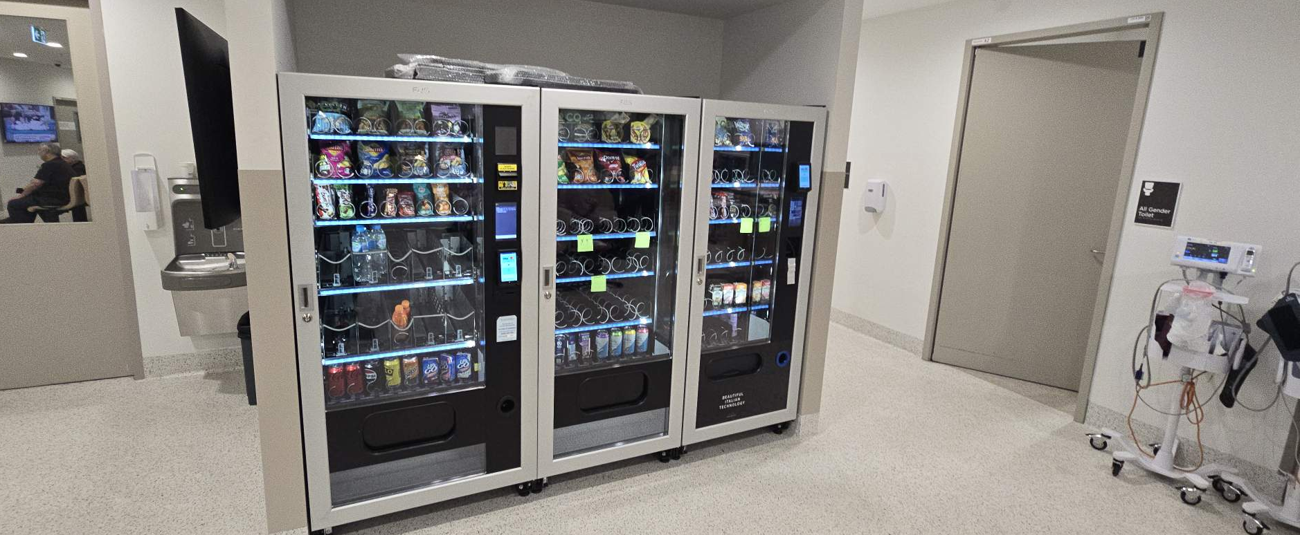 Free vending machines in a USA hospital emergency ward — snack, drink and combo bays for 24/7 staff and visitor access